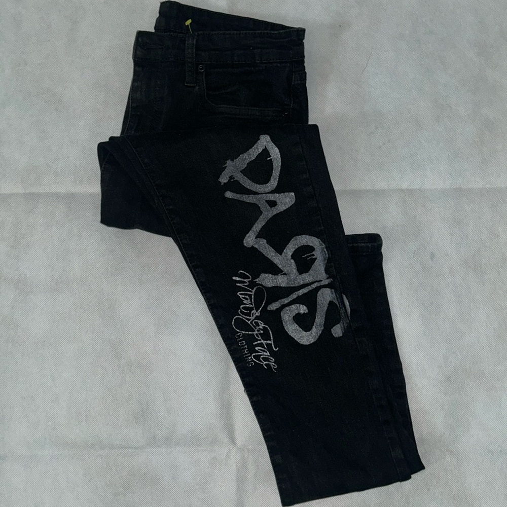 Black skinny jeans with spray paint style detail going down the leg size 30